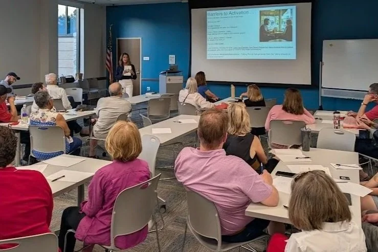 Community members taking part in a Town Talks Live workshop in a library meeting room.
